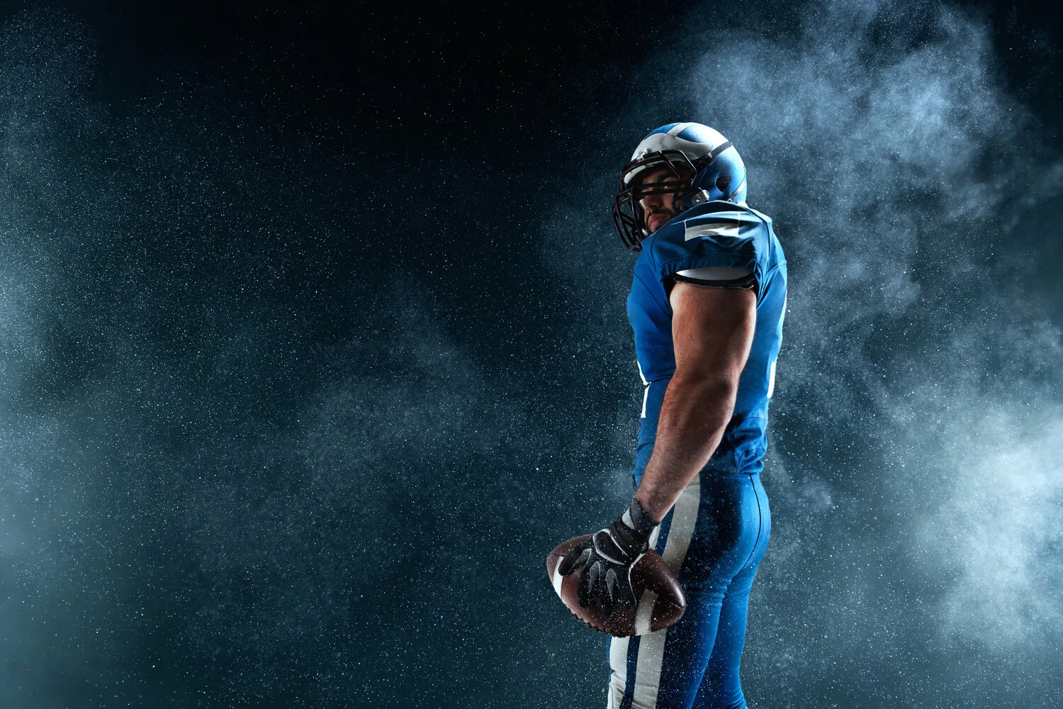 American football player on smoke background
